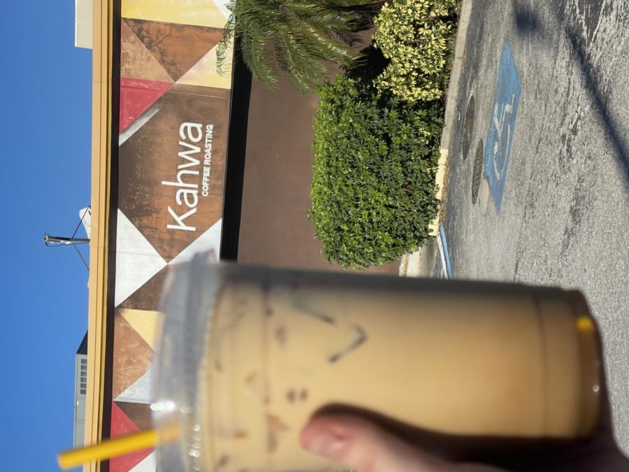 Picture of the iced caramel latte from Kahwa in front of their store off of Henderson Blvd.