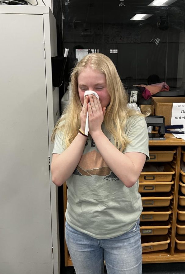 Peyton Price (24) blows her nose into a tissue.