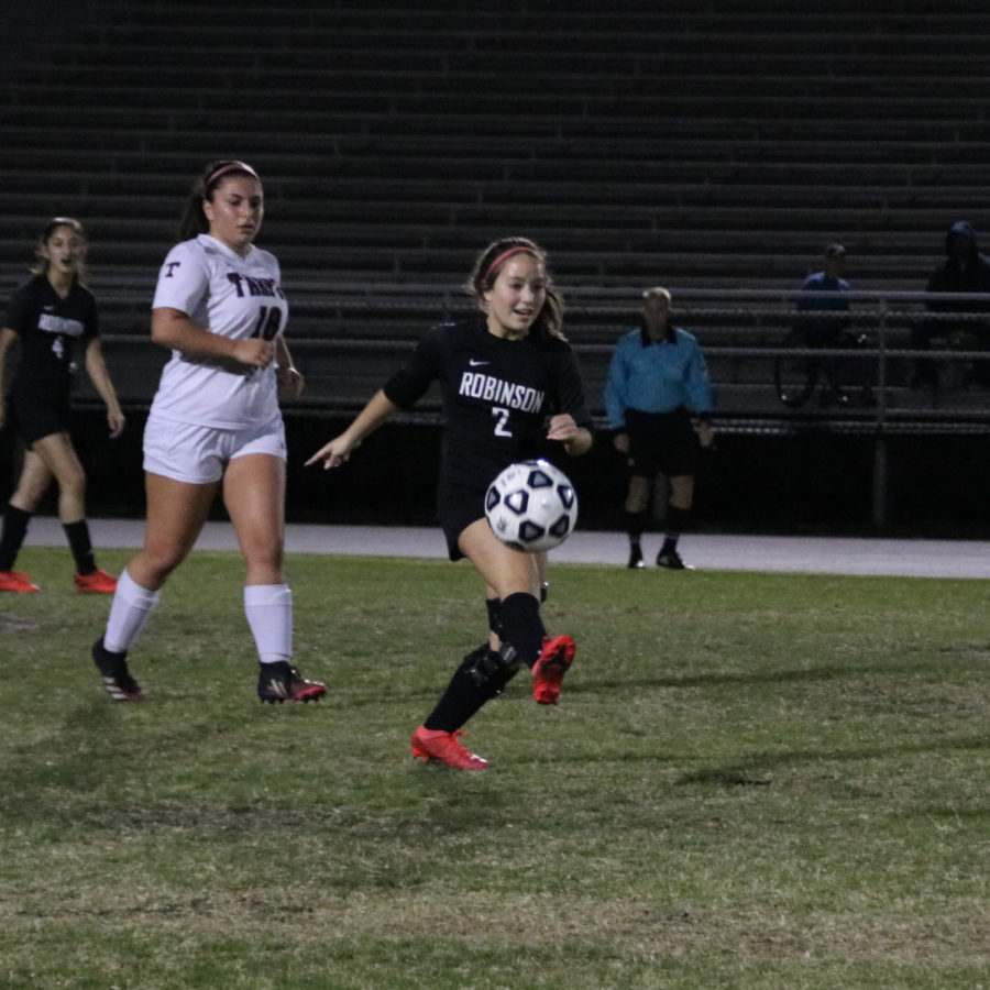 Valeria Aguirre (25) passing the ball downfield to a teammate.
