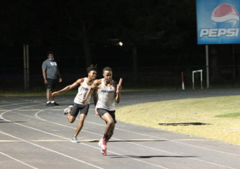 Justin Richardson (23) hands off the baton to Joshua Walker (22) in the 4x100 meter relay. The team won first place, making a great victory for Josh Walker and Juluan Johnson. 