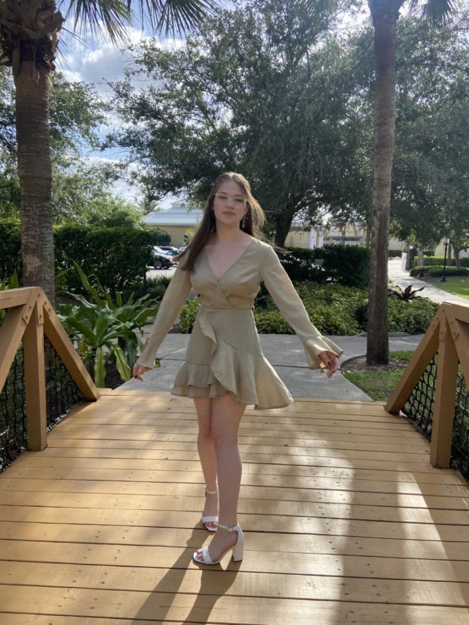 A sage green, flowy mini-dress, form Fashion Nova, acting as the monotone aspect of the outfit and the white heels acting as the attention grabbing bright color to tie together the perfect summer outfit.