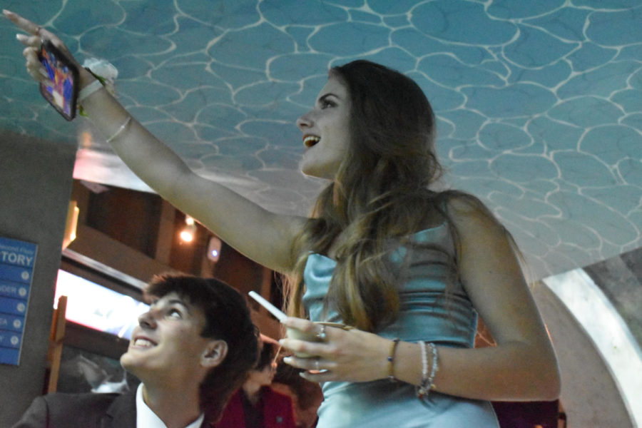 Maddie Llewelyn (23) observes the fish swimming by in the tank with her date, Creighton Koontz (24).