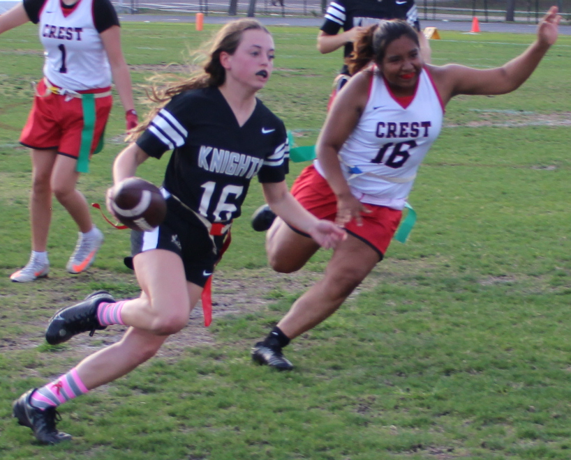 Cambell Moore (24) running past Strawberry Crest defenders to score.