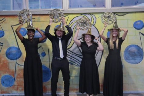 (From left to right) A’mrah Edmond (‘24), Garrett Sledge (‘22), Gabby Toranzo (‘25) and Sarah Blackshear (‘23) pose with  funky french horn hats outside the band room following the concert. As band comes to a close for the year, Blackshear reflects on her favorite parts. “I really love how everyone in the band feels like a family. I know thats really cheesy sounding but Revett and leadership do such an amazing job in making sure everyone has fun and feels welcome in everything music-related at Robinson.”