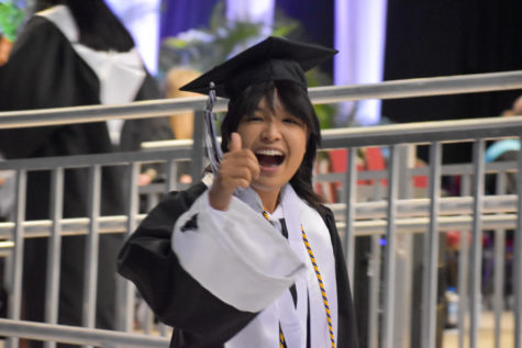 Pim Kruthun (22) smiles at the 2022 graduation as she comes off the stage after receiving her diploma. 