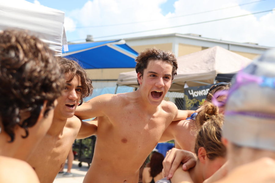 Casey Kemp (23) pumping up his fellow swim teammates during a swim meet.
