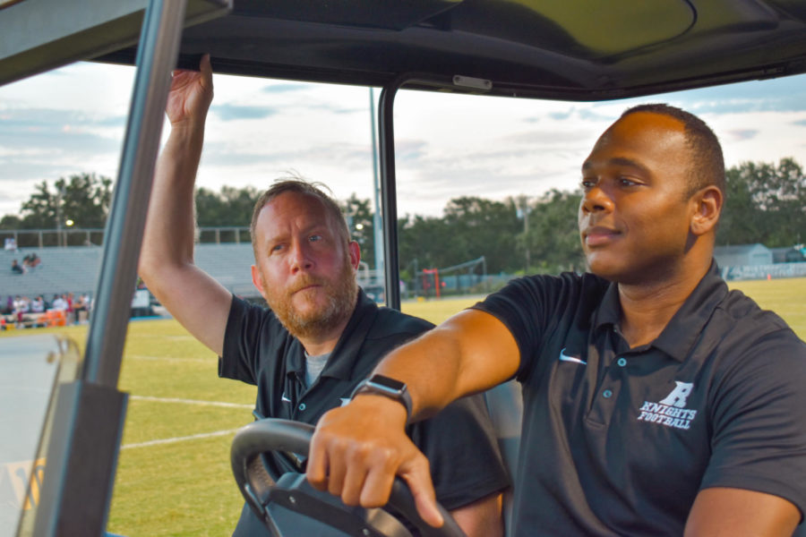 Bhoolai (right) with Assistant Principal of Curriculum Christopher Pettit in the golf cart they used to drive around the Jack Peters Field at football games, both of whom became familiar faces spotted every Friday night in the fall.