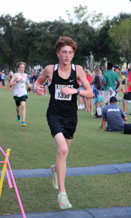 In the 2021-2022 season, Blake Arons (’25) races across the finish line at the Rogers Park Invitational Meet. 