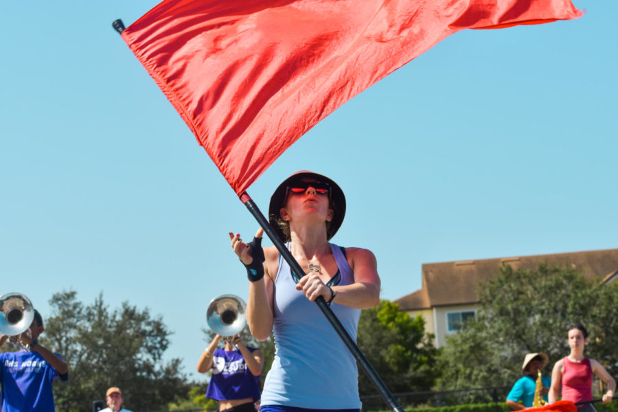 Gavyn Granger-Welch (23) spinning her flag as the band practices the marching routine.