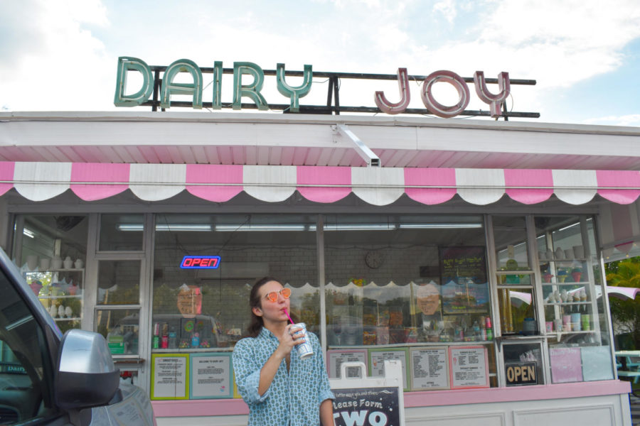 Kalani SIlva (23) sips his drink in front of the Dairy Joy sign.