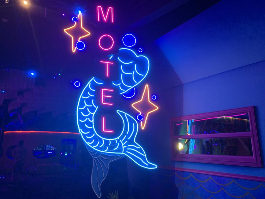 Neon mermaid motel sign located within the Fairgrounds immersive art installation.