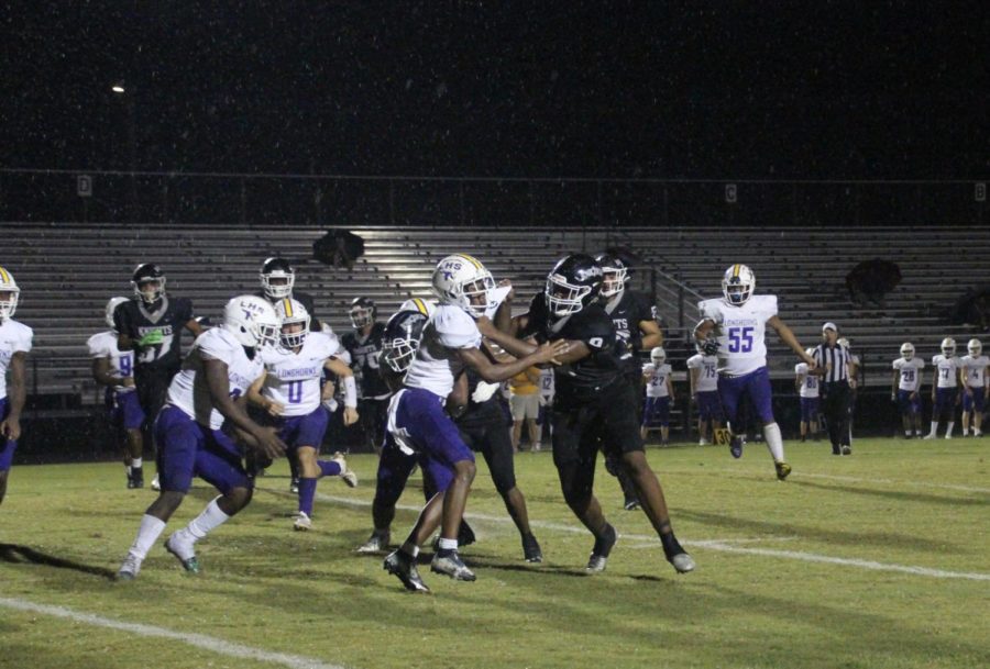 Samaud Jones ('24) playing defense and holding a Lennard player back.