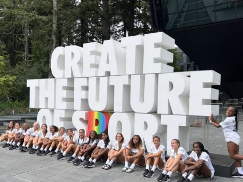 Robinson Girls Flag Football team poses in front of a sign that reads Create the future of sports outside of the Nike World Headquarters in Beaverton, Ore.