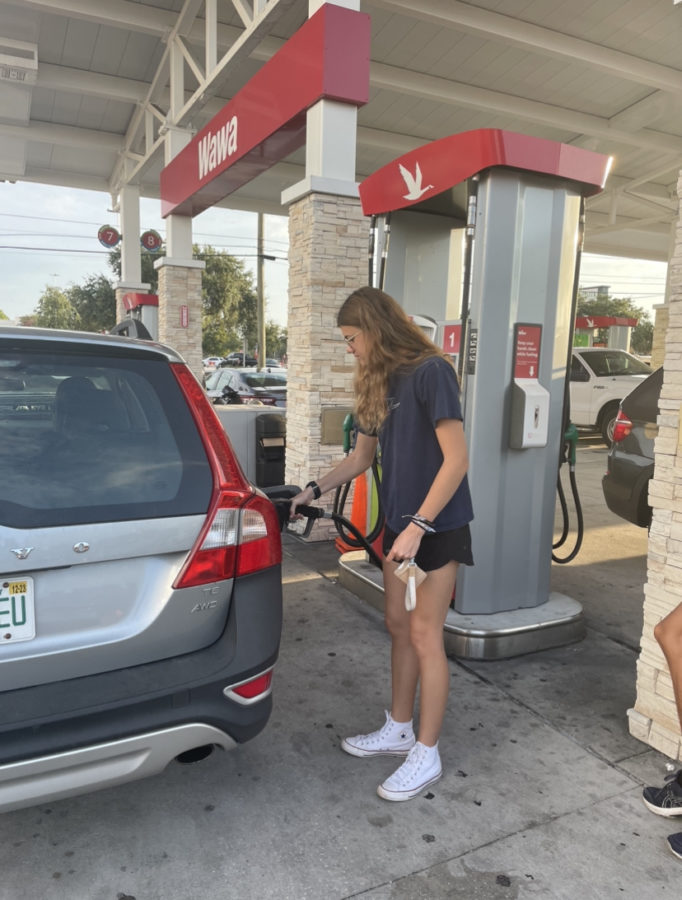 Ella Garruto (24) fills up her gas at the Wawa gas station.