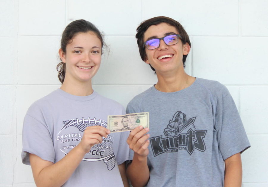 Bella Rodrigues (23) and Austin White (23) hold up a $5, the only money they have for their dream cheap date.