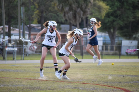 Girls Lacrosse team members going to snatch the ball in their 2021 season.