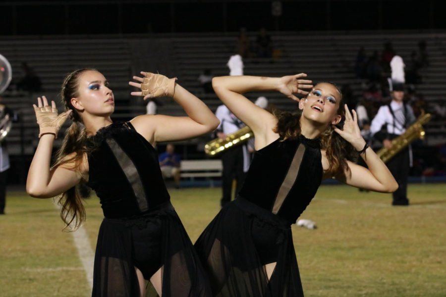 Sean Griglio (23) and Sierra Hatton (24) swaying back and forth as part of the visual aspect in the marching show.