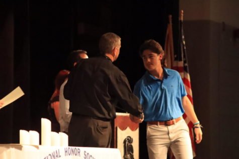 Maddox Thomas (24) shaking Principal David Browns hand on his way to receive his certificate of induction into the National Honor Society. 