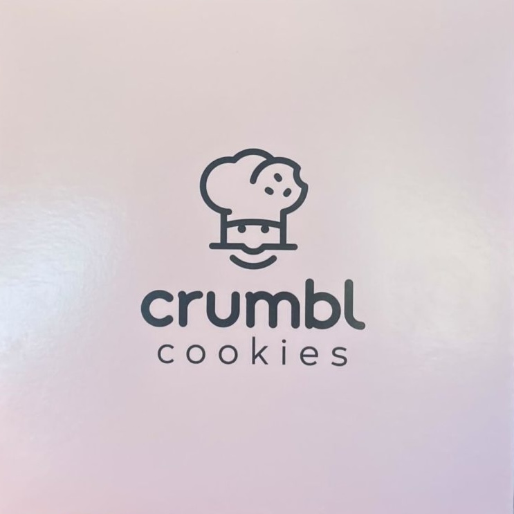 The front of the Crumbl Cookies box for a singular cookie. The pastel pink box catches your attention from miles away. 