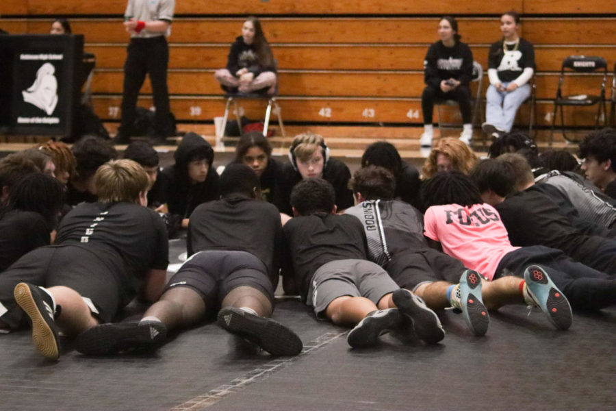 The varsity team meeting before the match begins.