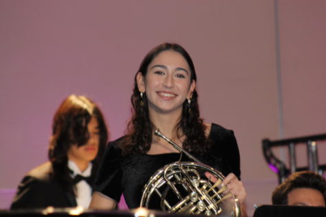Grace Barrett (23) posing with her French Horn while rehearsing for her performance with the All-State Symphonic Orchestra. 