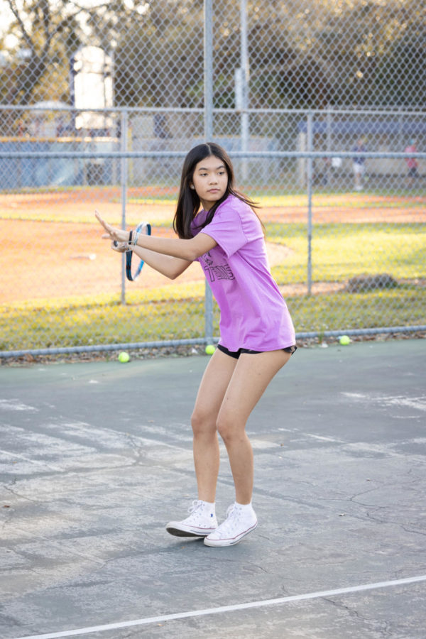 Sophie Le (26) taking a swing on the tennis court.