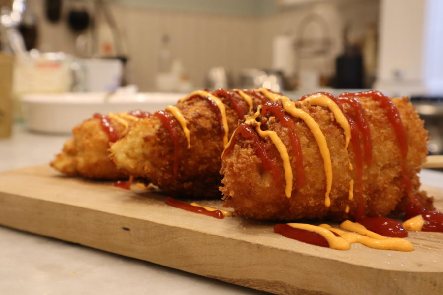 Golden brown corndogs drizzled in ketchup and spicy siracha-mayo. 