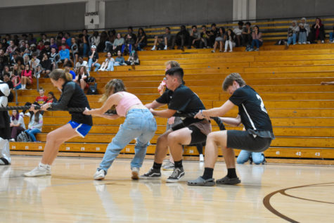 (From left to right) Captains Issa Allbritton (23) Sophia DAmore (24), Dominic Demmicco (24) and Liam Doyle (23) represent the girls and boys lacrosse teams in the Captains Tug of War. The lacrosse players lost this game of strength to the boys and girls tennis team captains. 