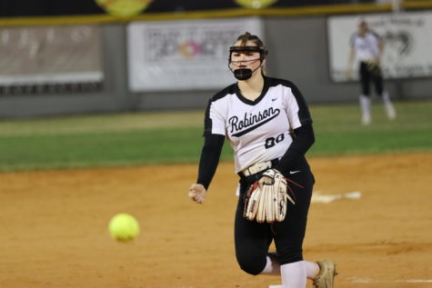 Kohana Pousson (23) releases the ball from her hand as she finishes her pitch. 