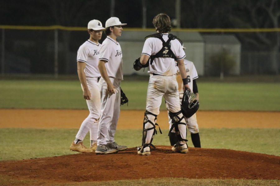 (From Left to Right) Tucker Wehrman ('23), Samuel Hyman ('26), Brady Capps ('25) and Ryan Sawdy ('25) gather at the pitcher's pound for a meeting.