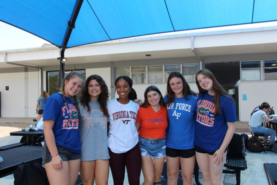 (From left to right) Seniors Abbi Fishman, Maya Roush, Cami Sai, Callie Tipton. Skyllar Erikson and Madison Williams smile in their college shirts. College decision day happened on Tuesday, April 25 for Robinsons Class of 2023. Seniors wore their college shirts and had a chance to display the college they chose on a banner inside the cafeteria.