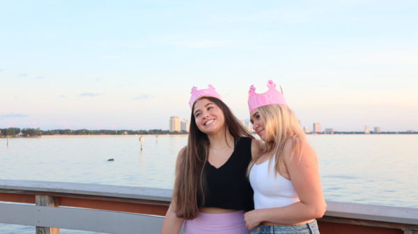 Sara Lebron (24) and Sienna Epstein (24) smiles at their friend as they get a picture taken together at senior sunrise. The annual senior sunrise happened on Thursday, Aug. 10 at Ballast Point Park. 