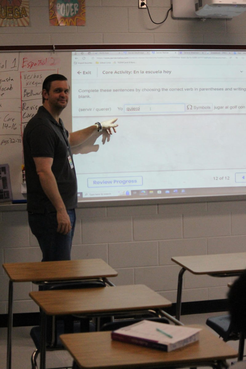 Jason Kochalka points at his board in his classroom. 