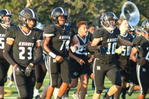 The Knights charge the field before facing off against a team