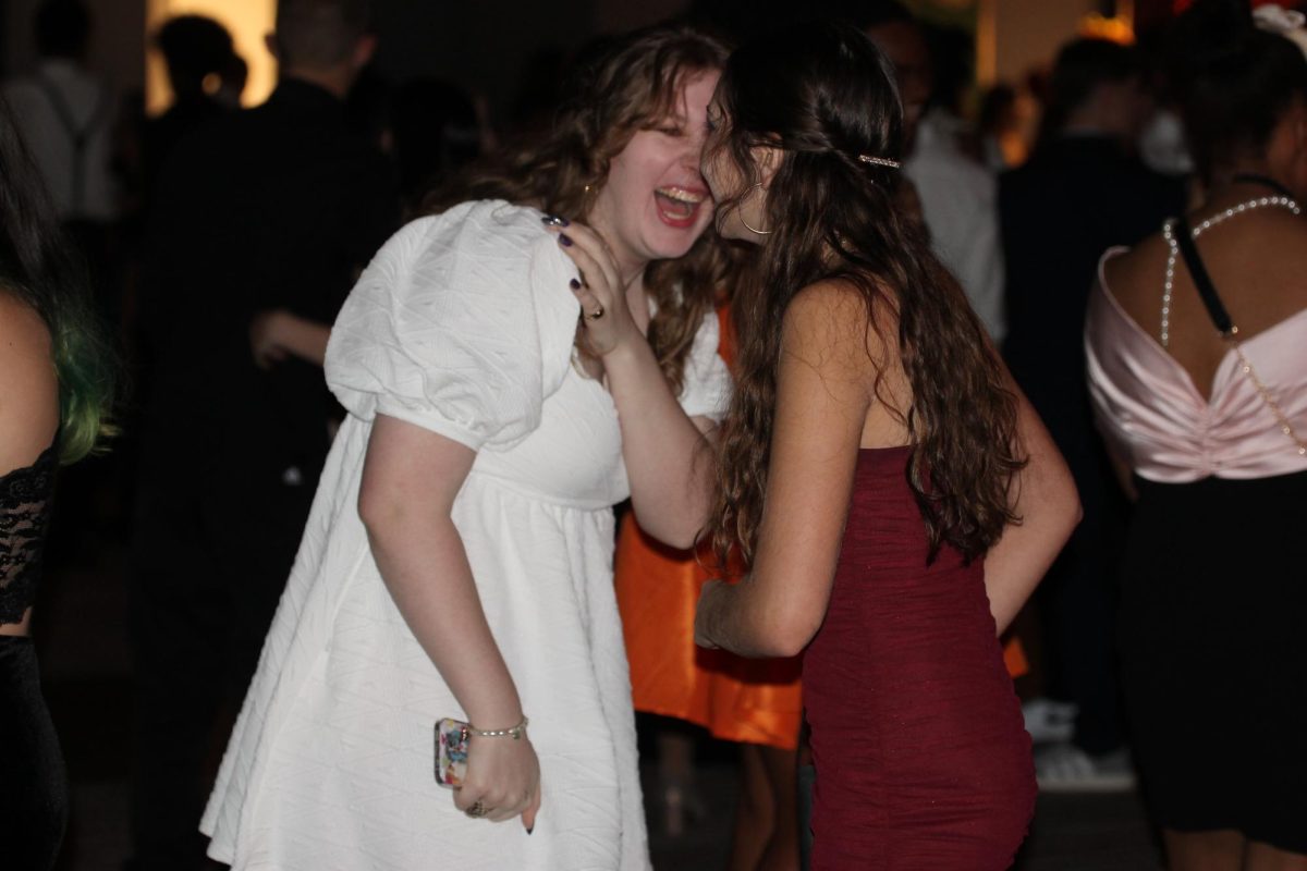 Kiersten Schreiber (25) and Isabel Trier (25) laugh on the dance floor as they celebrate the highly anticipated Homecoming dance. 