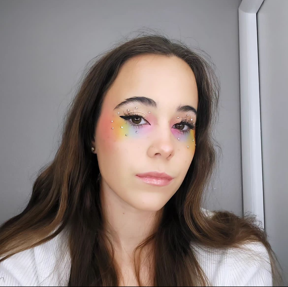 Alivia Cocchiola’s (‘25) most recent makeup look of a rainbow blended eye shadow look. 