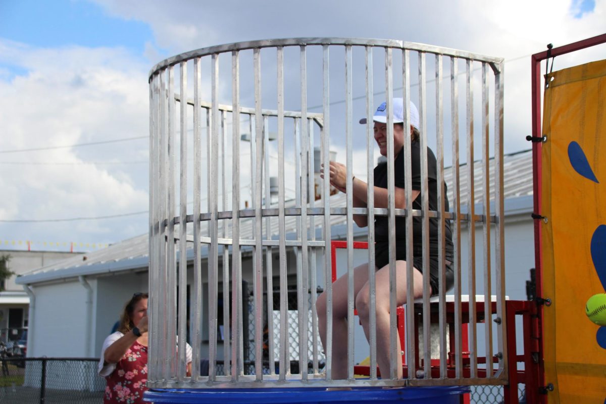 Biology Teacher Sarah Sanford sits as she is ready to be dunked. The dunk tank was one of the many games present at the festival PTSA hosted last year. 