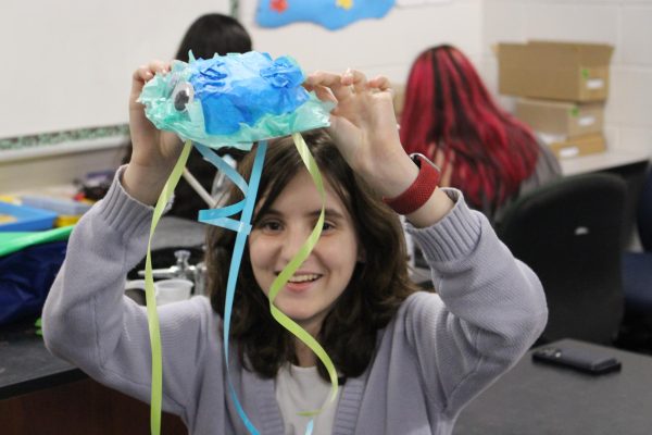 Lauren Williams (27), Showing off arts and crafts project at the Marine Biology Club Meet on Club Day. 