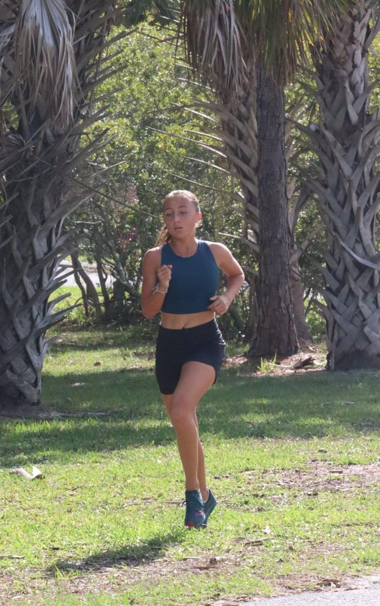 Brennan Baryza (27) runs at one of the girls cross-country teams practices. 