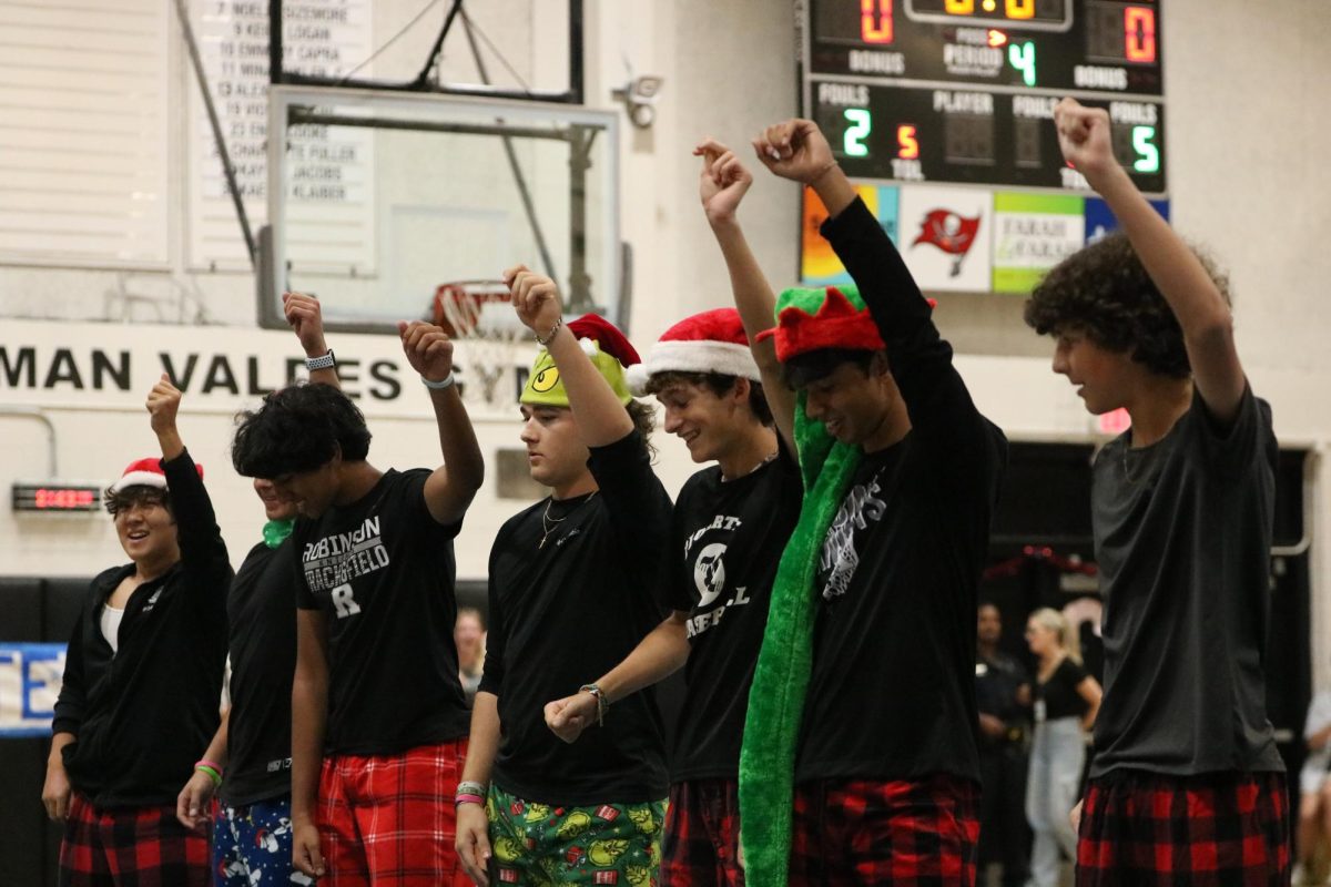 The spirit boys dance to Jingle Bell Rock at the Winter pep rally. 