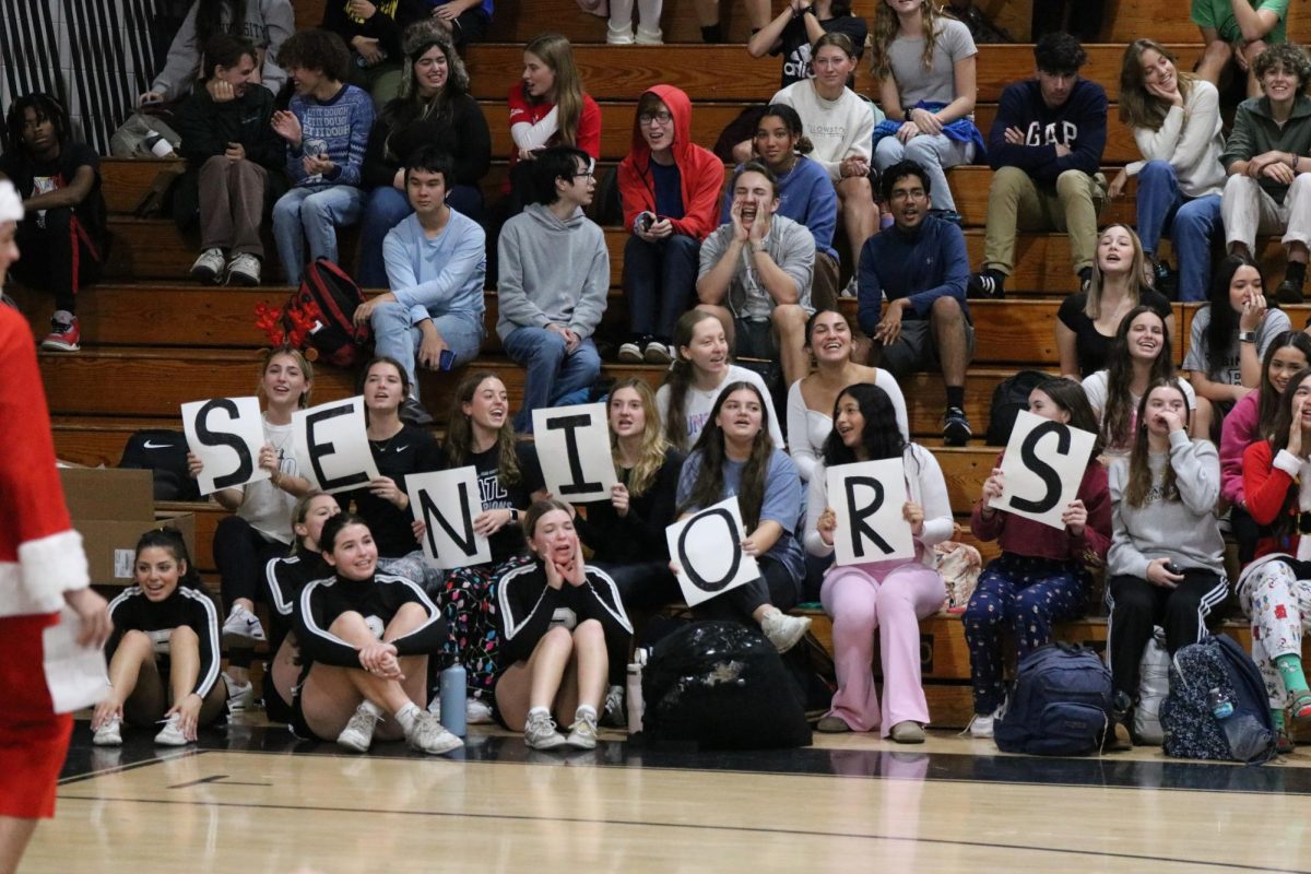 The senior section holds up letters that spell "SENIORS."