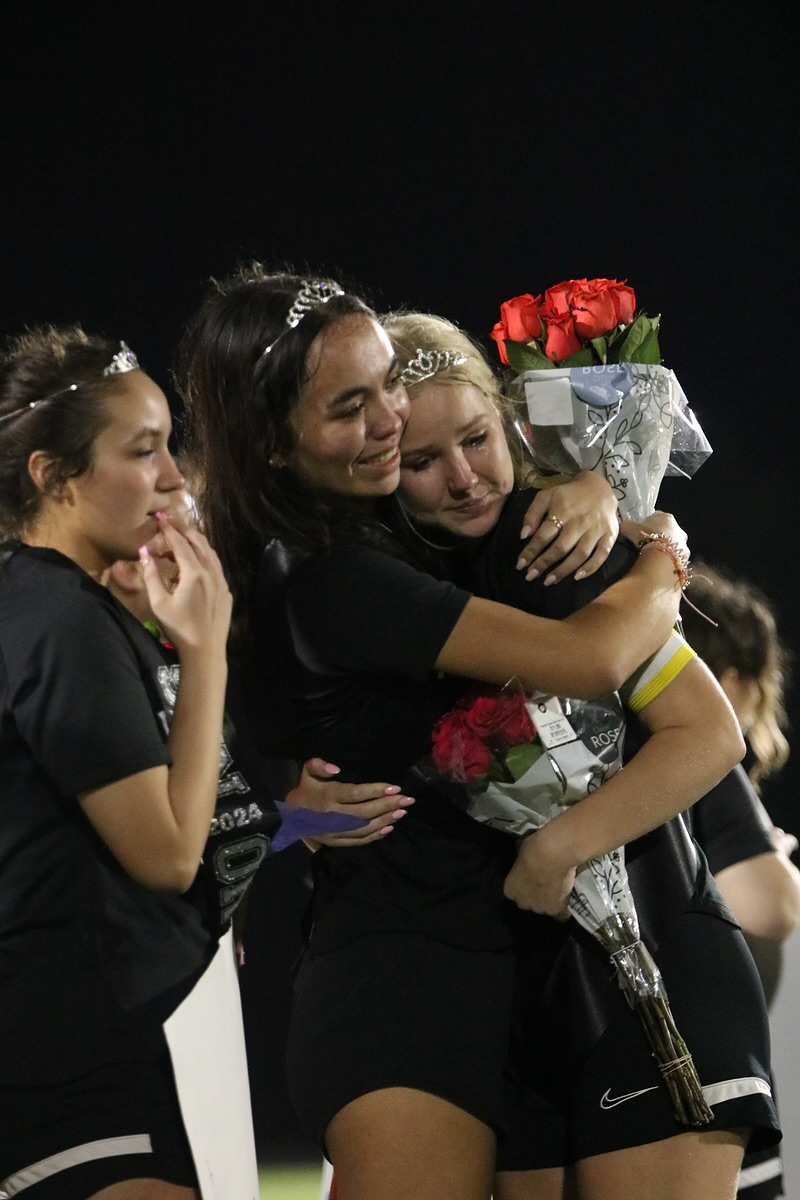 Seniors Corinne Schear and Keira Logan hug each other on Soccer senior night. 