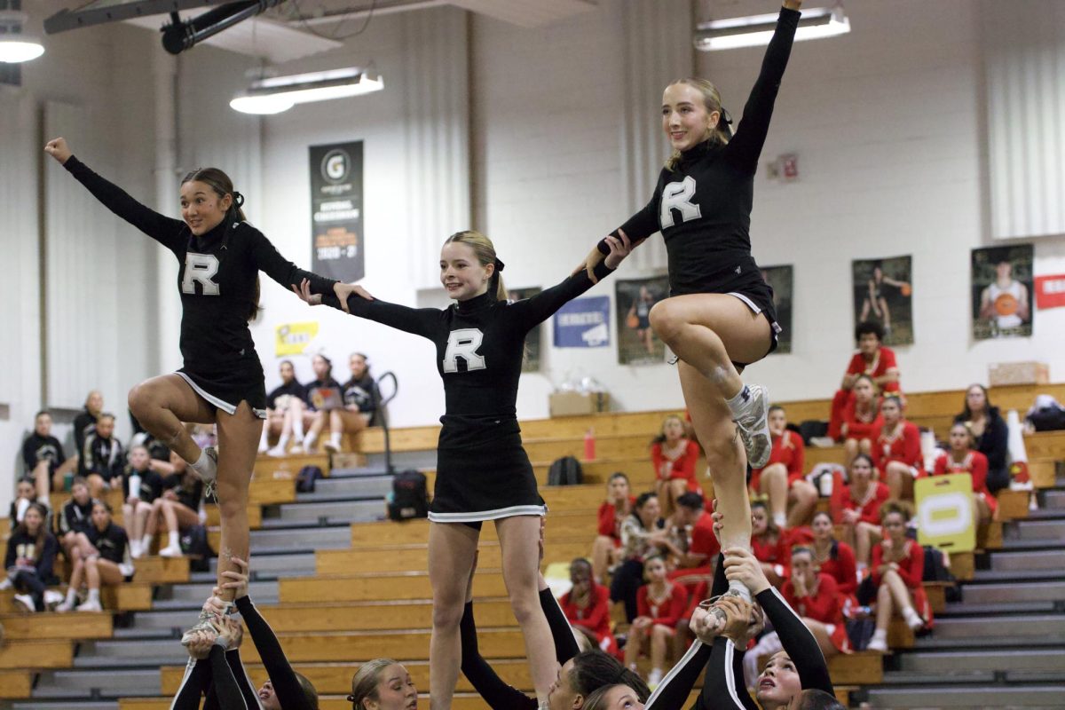 (From left to right) Maile Abel (26), Katelyn Boyd (26) and Laura Smith (26) stand strong during stunt. 