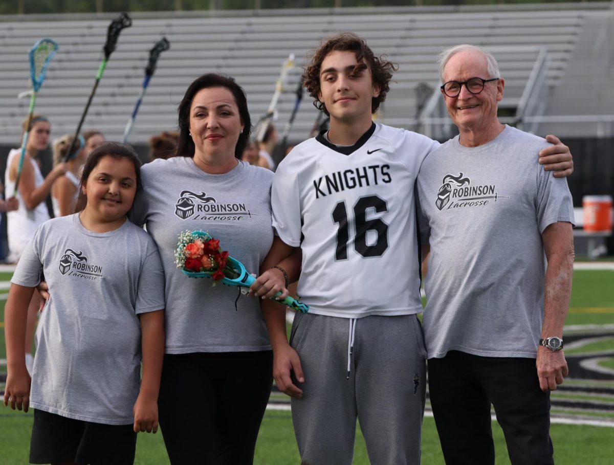 Christian Noriega poses with his family during senior night.