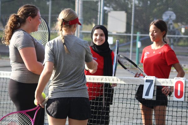 Doubles players Autumn Lebron (26) &
Lillian Walker (26) greet their Bloomingdale opponents.