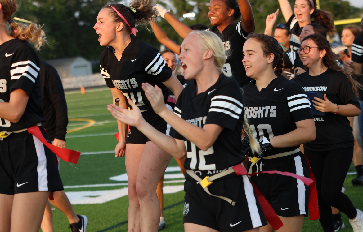 The varsity flag football team celebrates another touchdown during the district finals game.