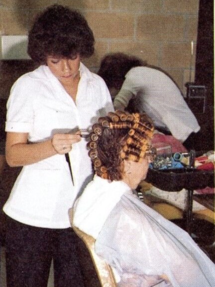 A 1981 Robinson student practicing on a teacher in the cosmetology class.