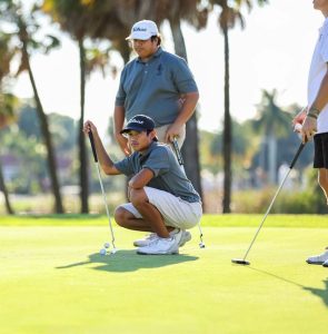 Team Golfers Colton Fair ('25) and James Arong ('27) trading strokes during match. 