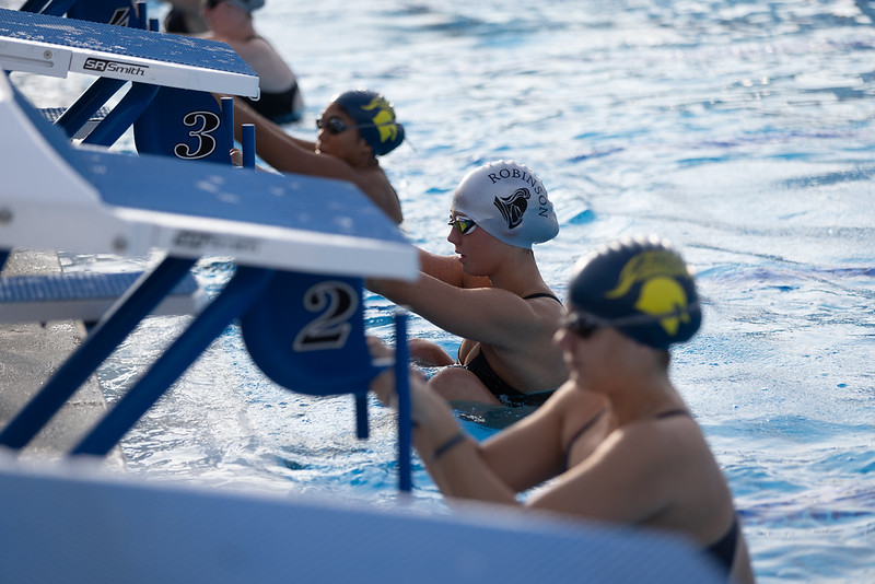 Getting ready for a back-stroke race, Adeline Cloutier positions herself on the start block. 