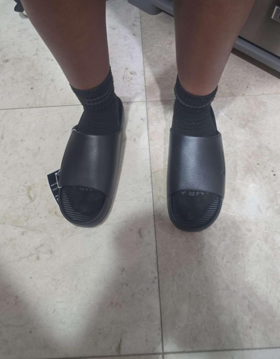 A student sporting the socks and sliders combo on their way to school.